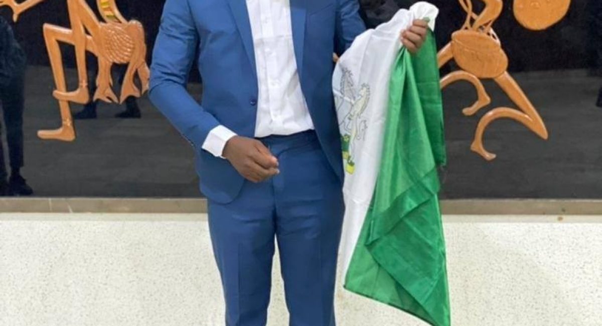sheddy green with the Nigerian flag